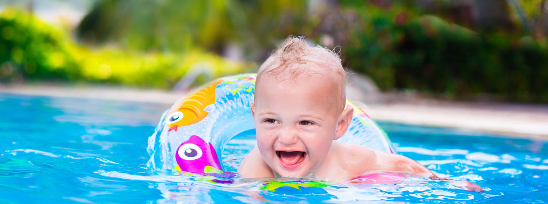 Baby swimming in fibreglass pool